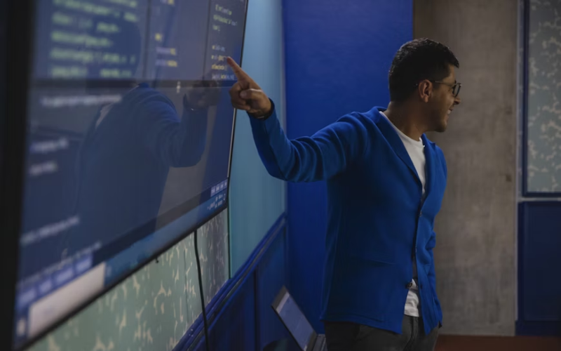 Two developers working on screens in an open office.